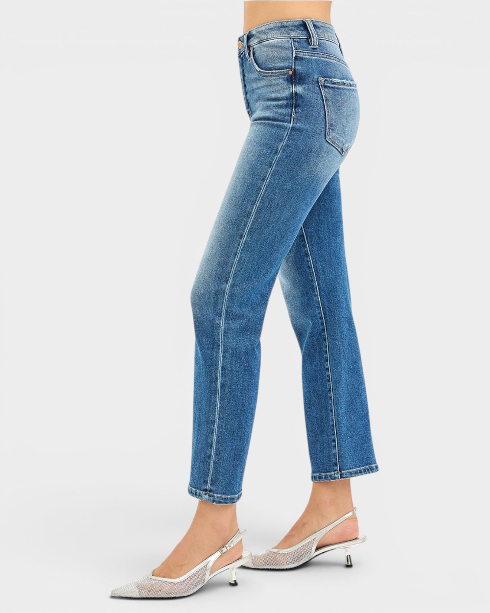 Blue jeans worn by a person on a white background