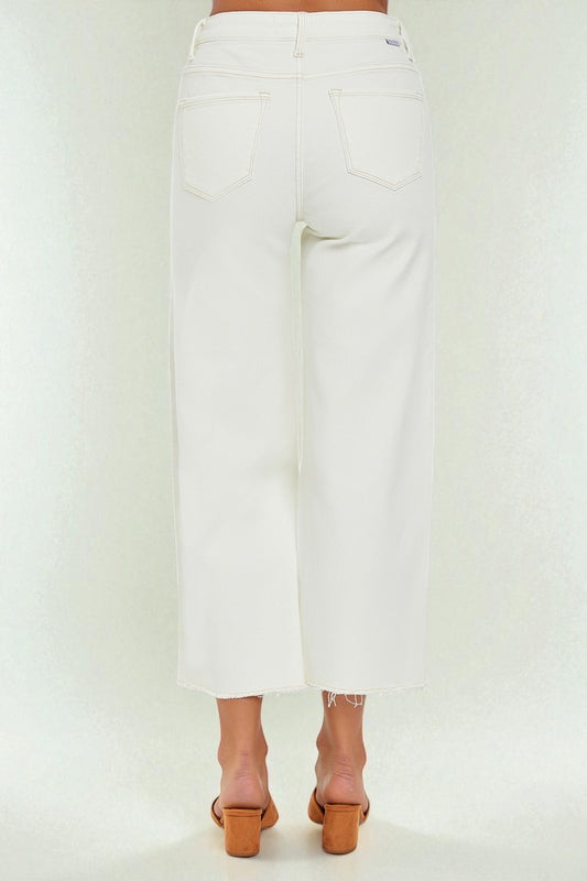 White pants worn by a person on a white background