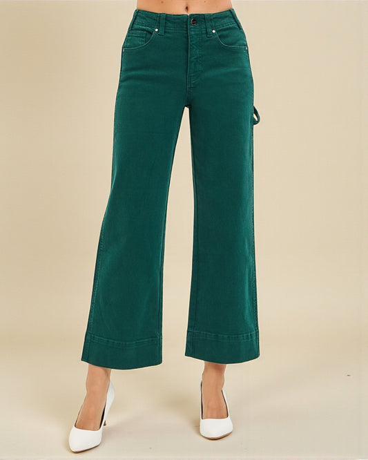 Green wide-leg pants worn by a person on a beige background