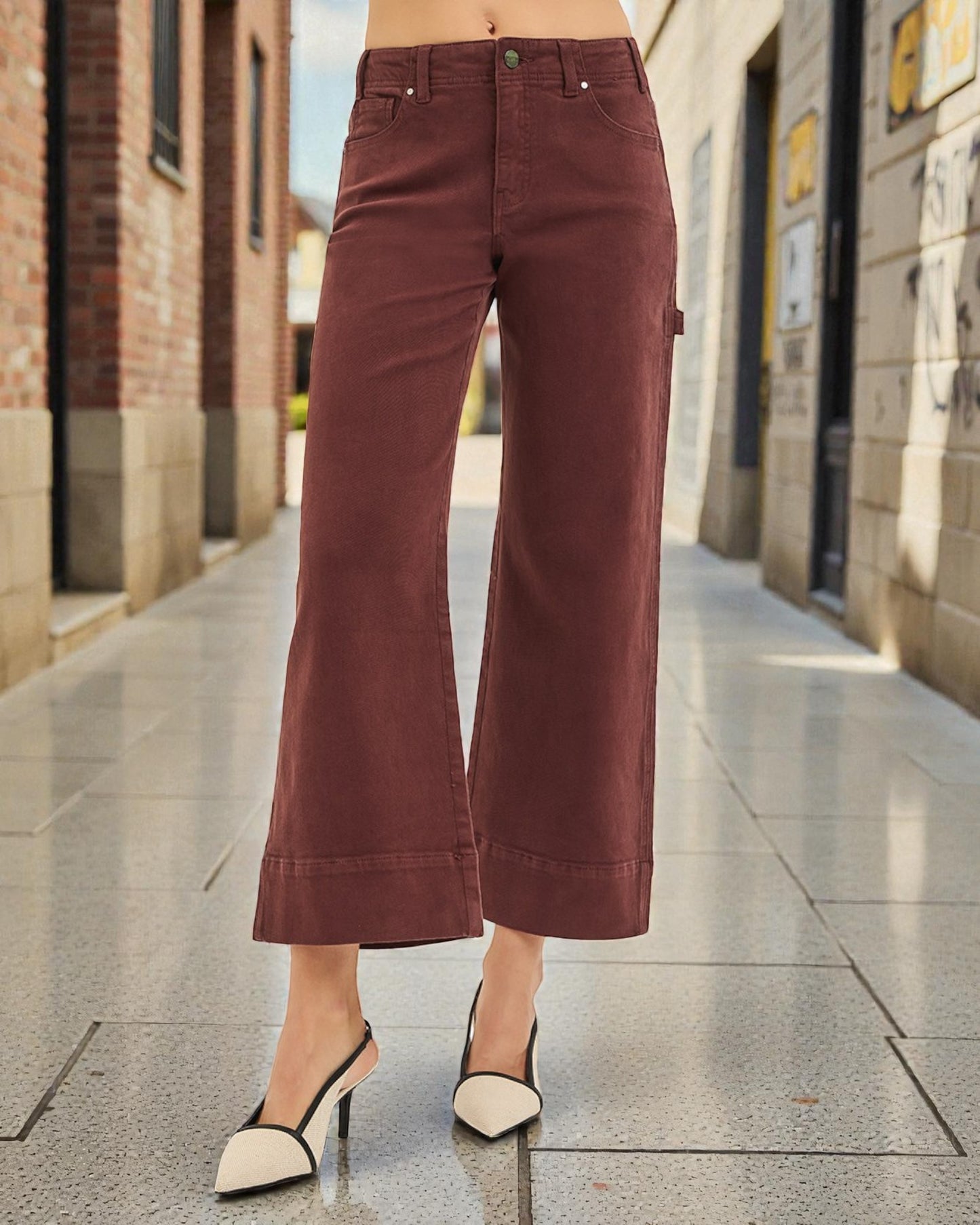 Maroon wide-leg pants worn by a person on a city street.