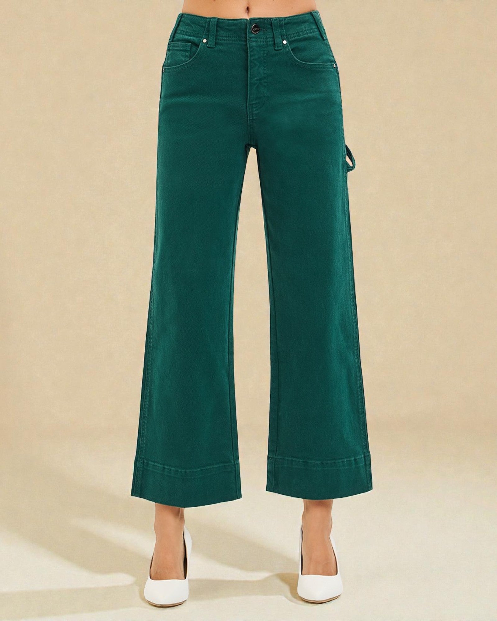 Green wide-leg pants worn by a person on a beige background