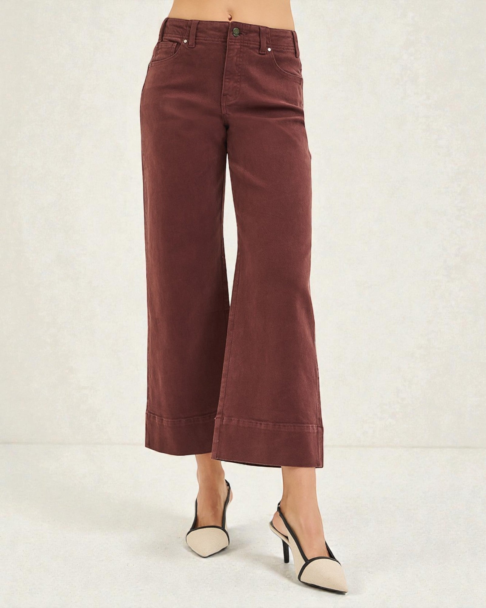 Brown wide-leg pants worn by a person on a white background