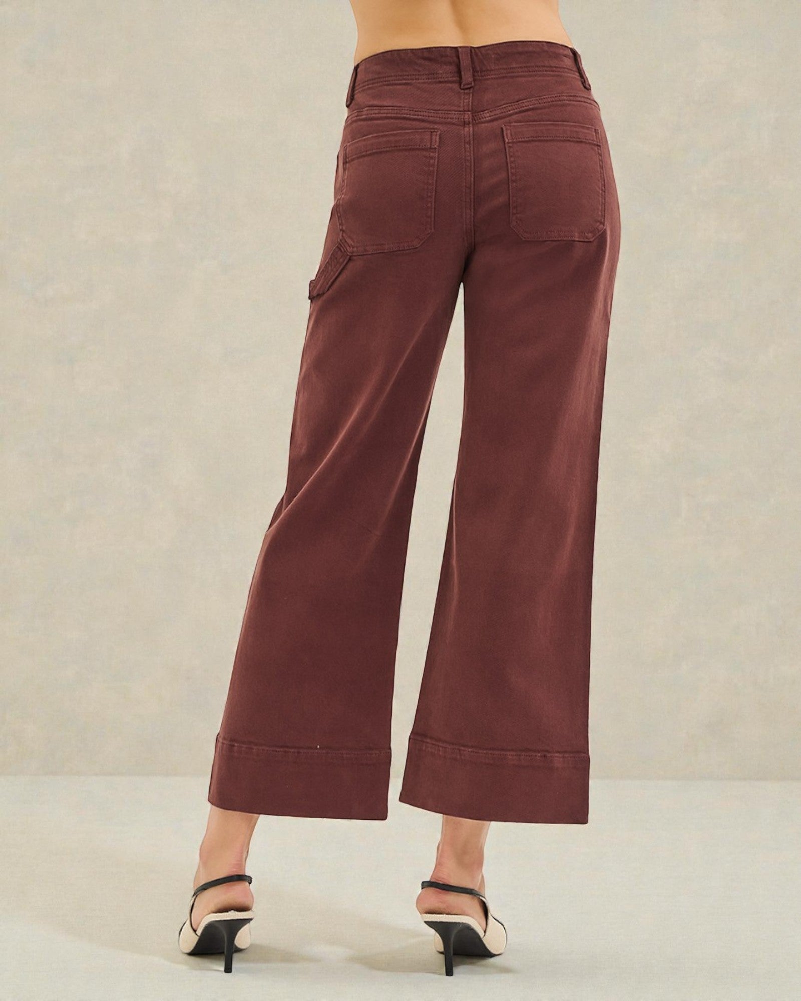 Brown wide-leg pants worn by a person on a neutral background