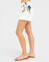 White shorts with floral print worn by a person on a white background