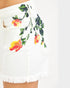 White shorts with colorful floral print on a white background