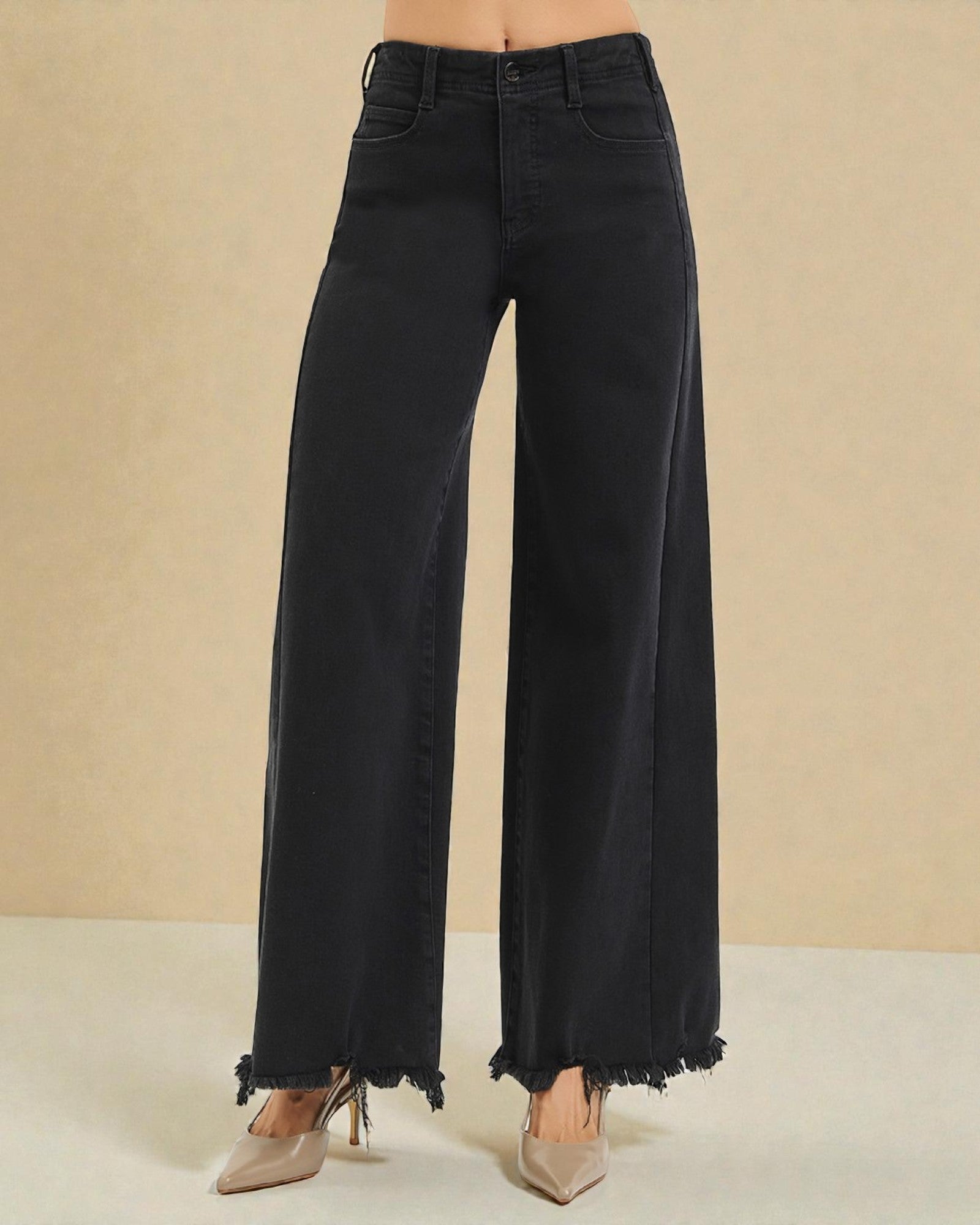 Black wide-leg jeans on a beige background