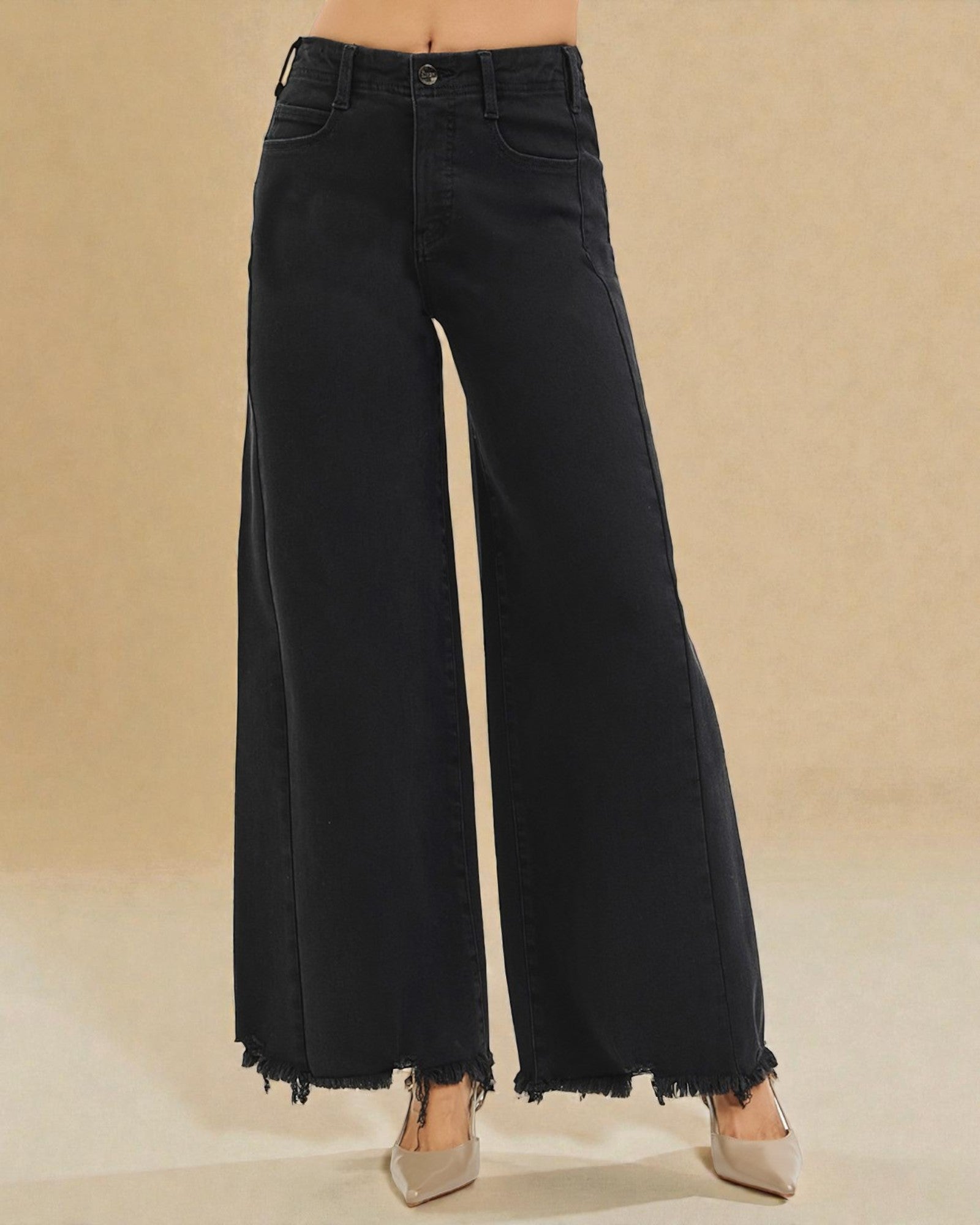Black wide-leg jeans on a beige background