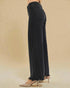 Black wide-leg pants worn by a person on a beige background