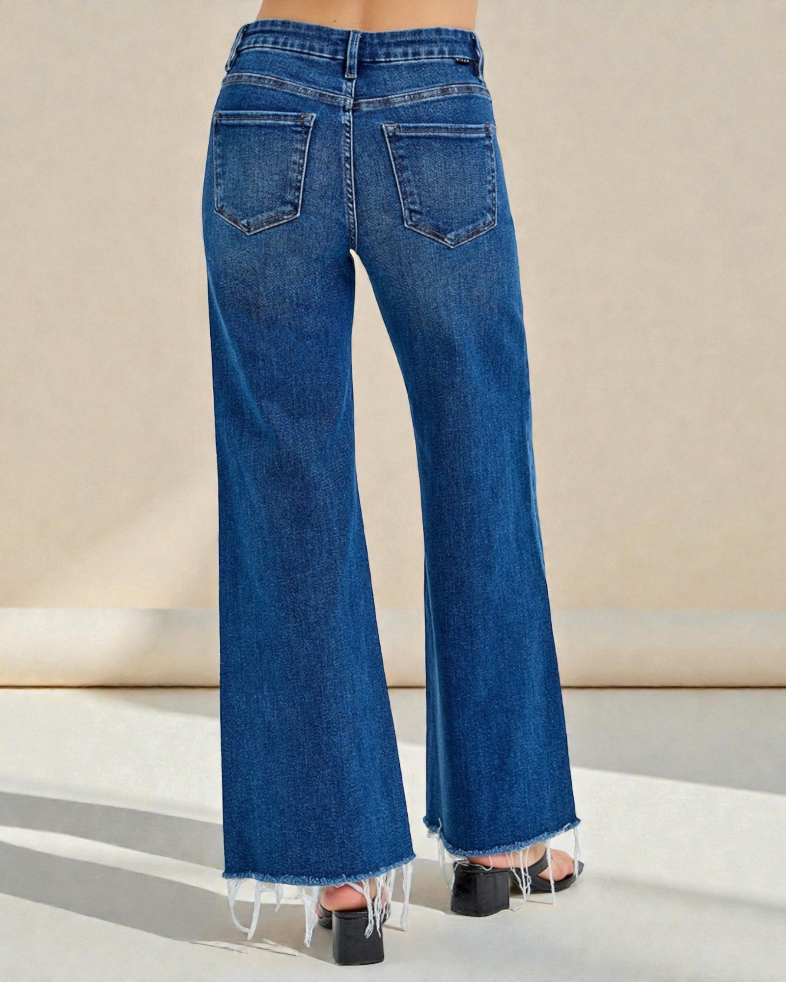 Blue wide-leg jeans on a neutral background