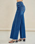 Blue jeans worn by a person on a beige background