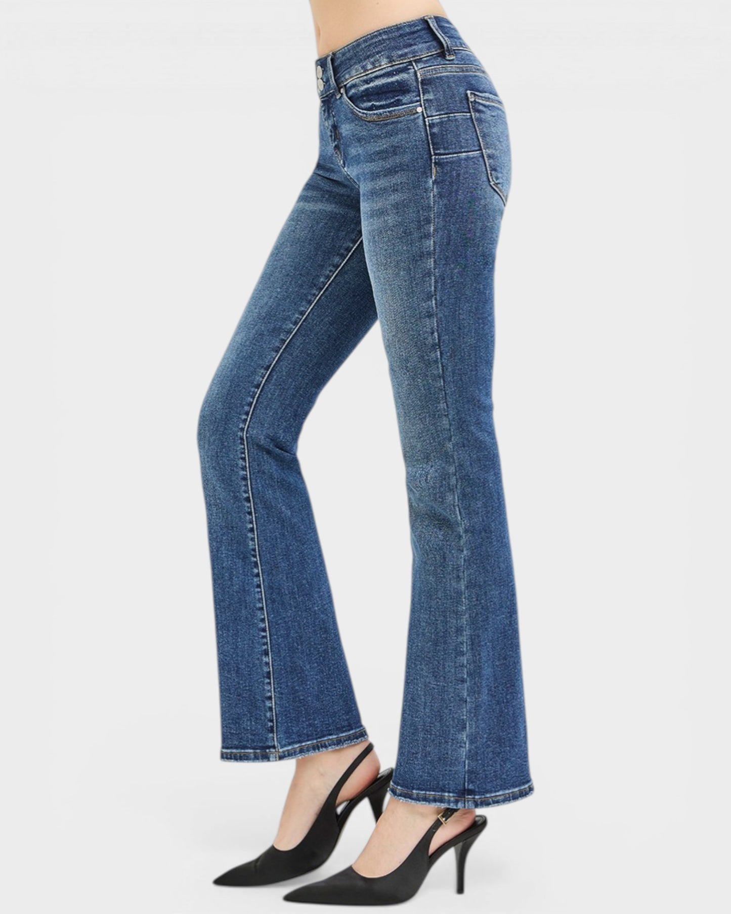 Blue jeans worn by a person on a white background