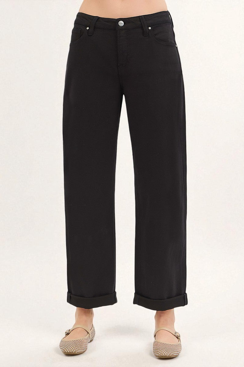 Black jeans worn by a person on a white background