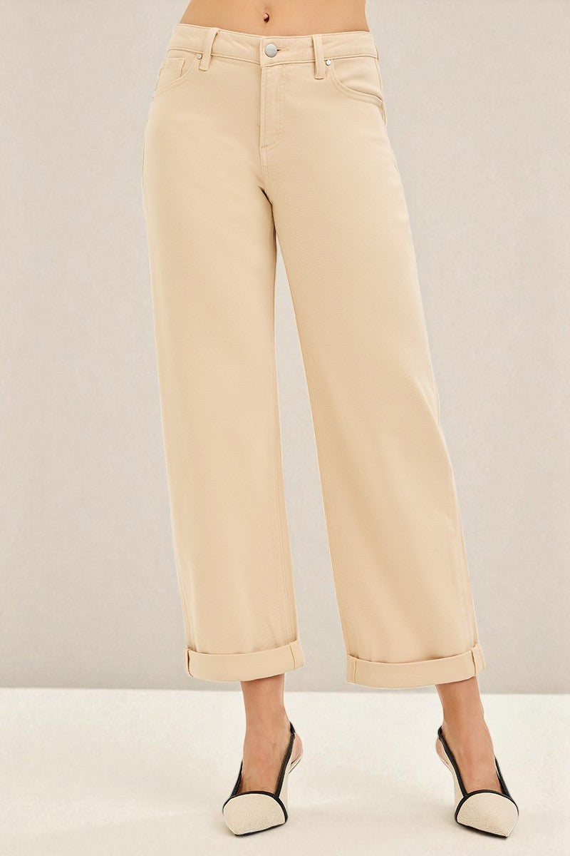 Beige pants worn by a person on a plain background