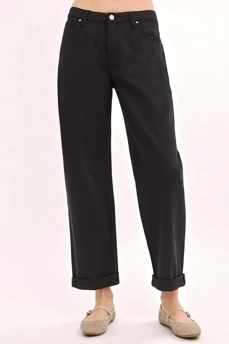 Black pants worn by a person on a white background