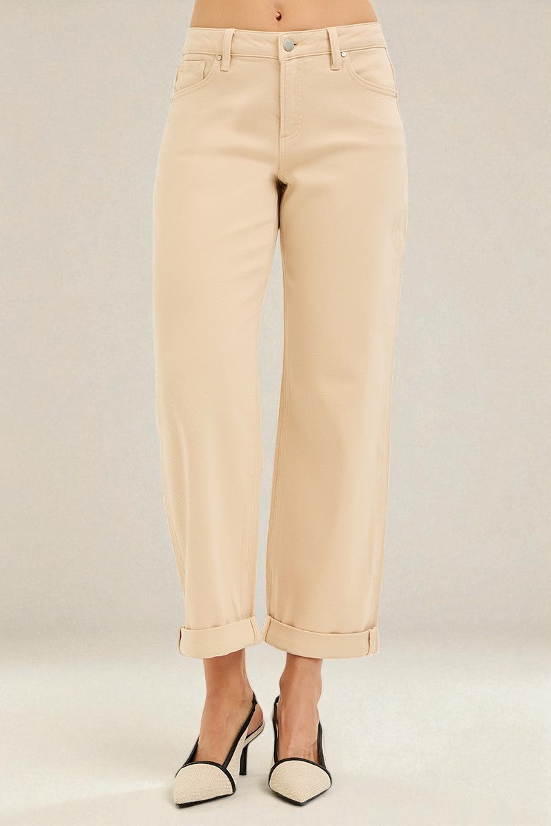 Beige pants worn by a person on a plain background