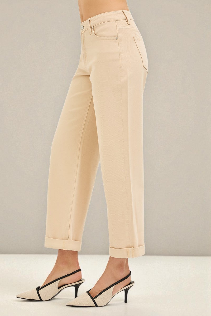Beige pants worn by a person on a plain background