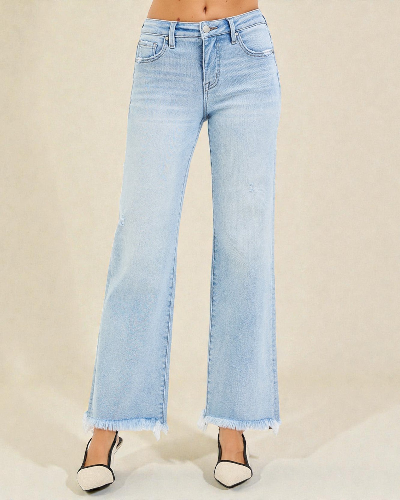 Light blue flared jeans on a beige background