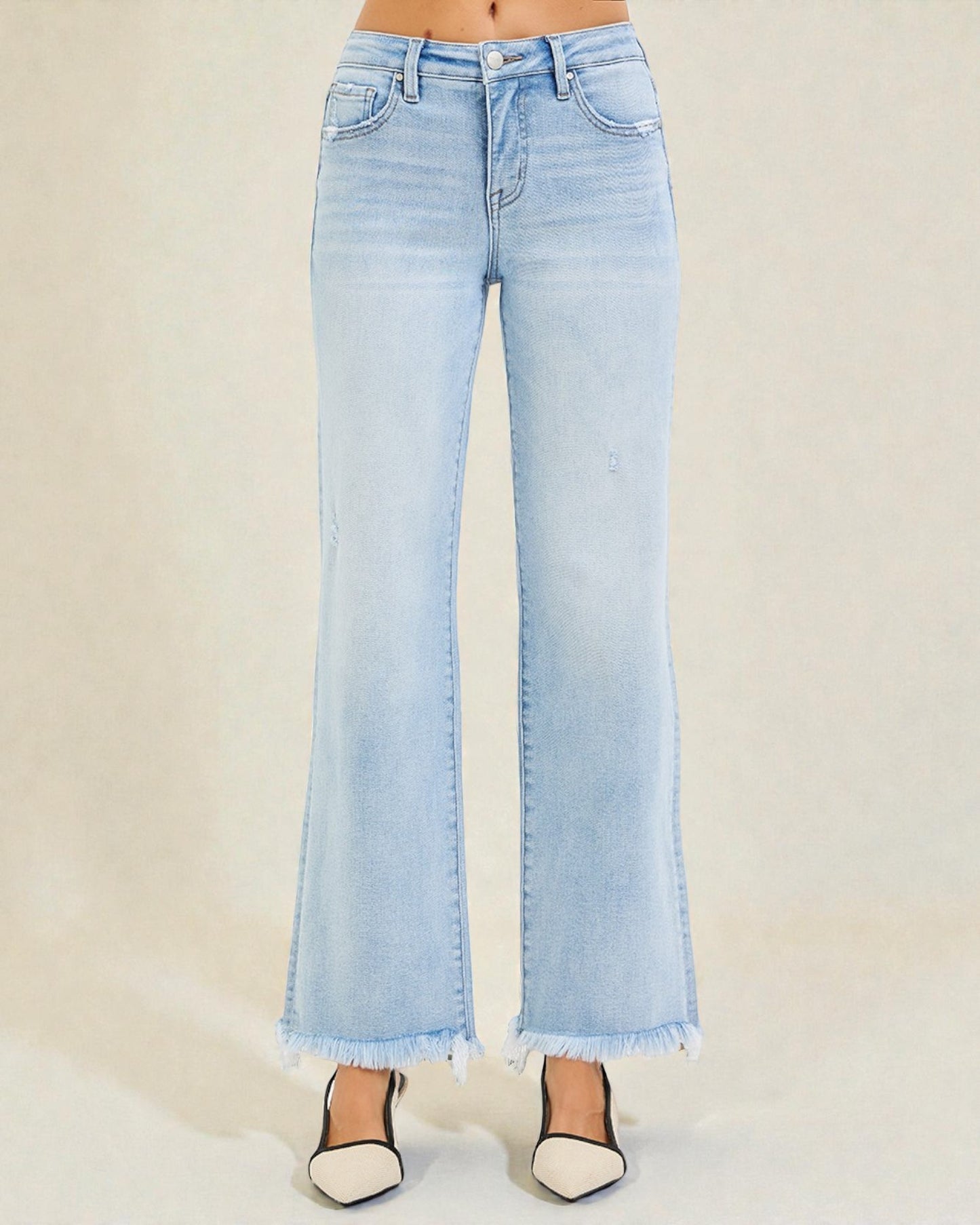 Light blue flared jeans on a plain background