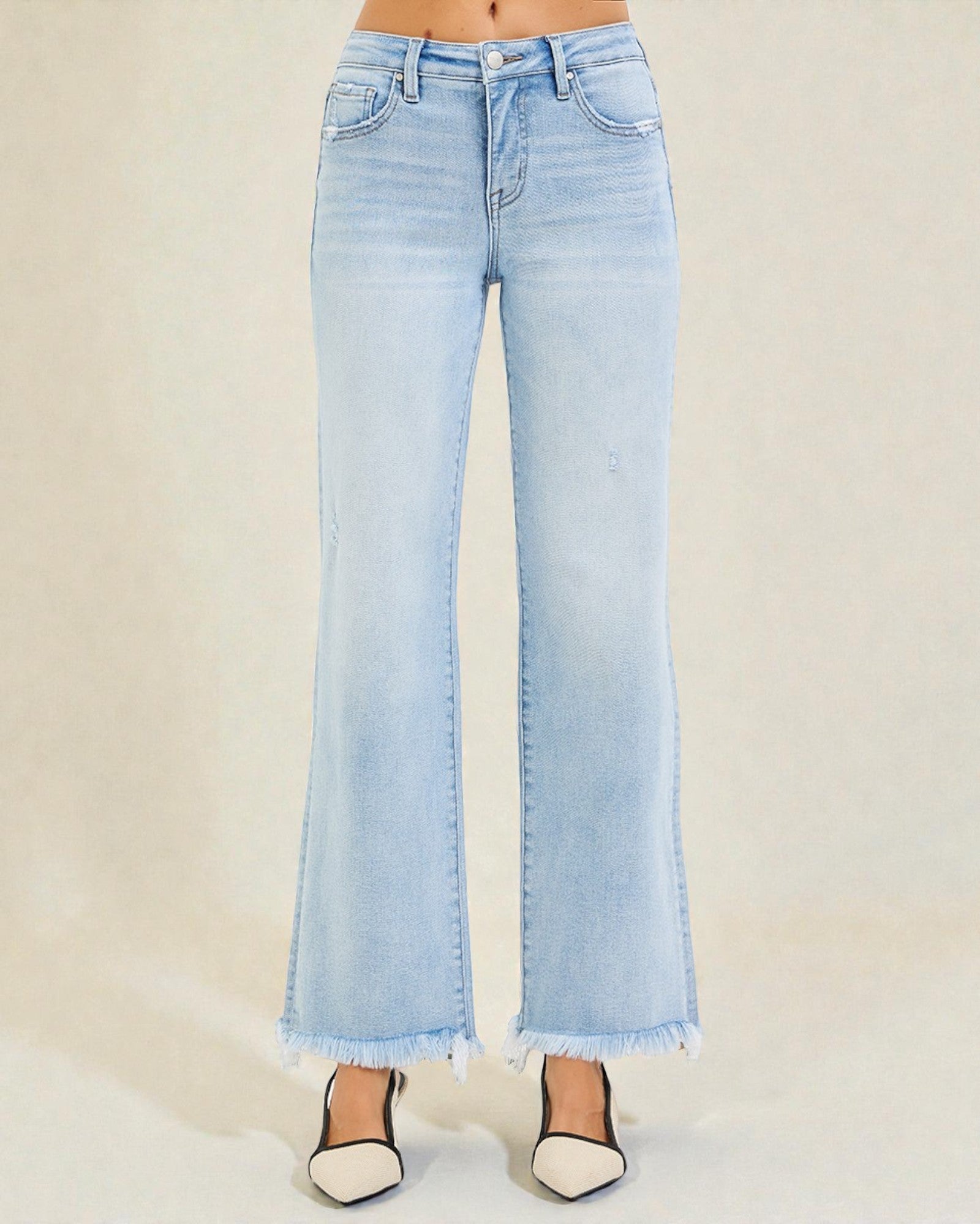 Light blue flared jeans on a plain background