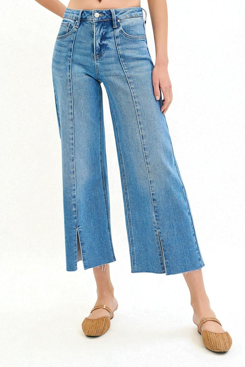 Blue jeans worn by a person on a white background