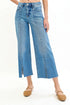 Blue jeans worn by a person on a white background