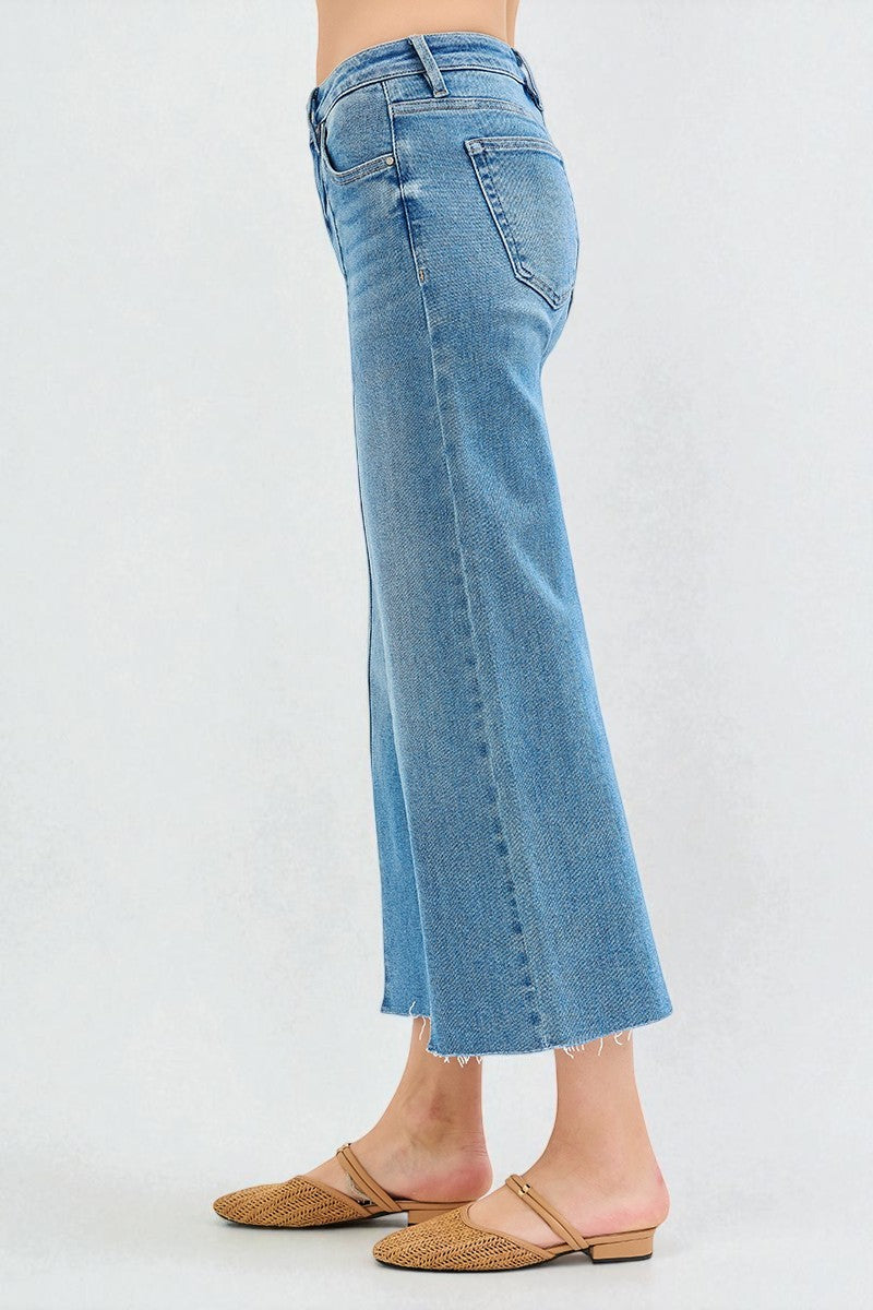 Blue jeans worn by a person on a white background