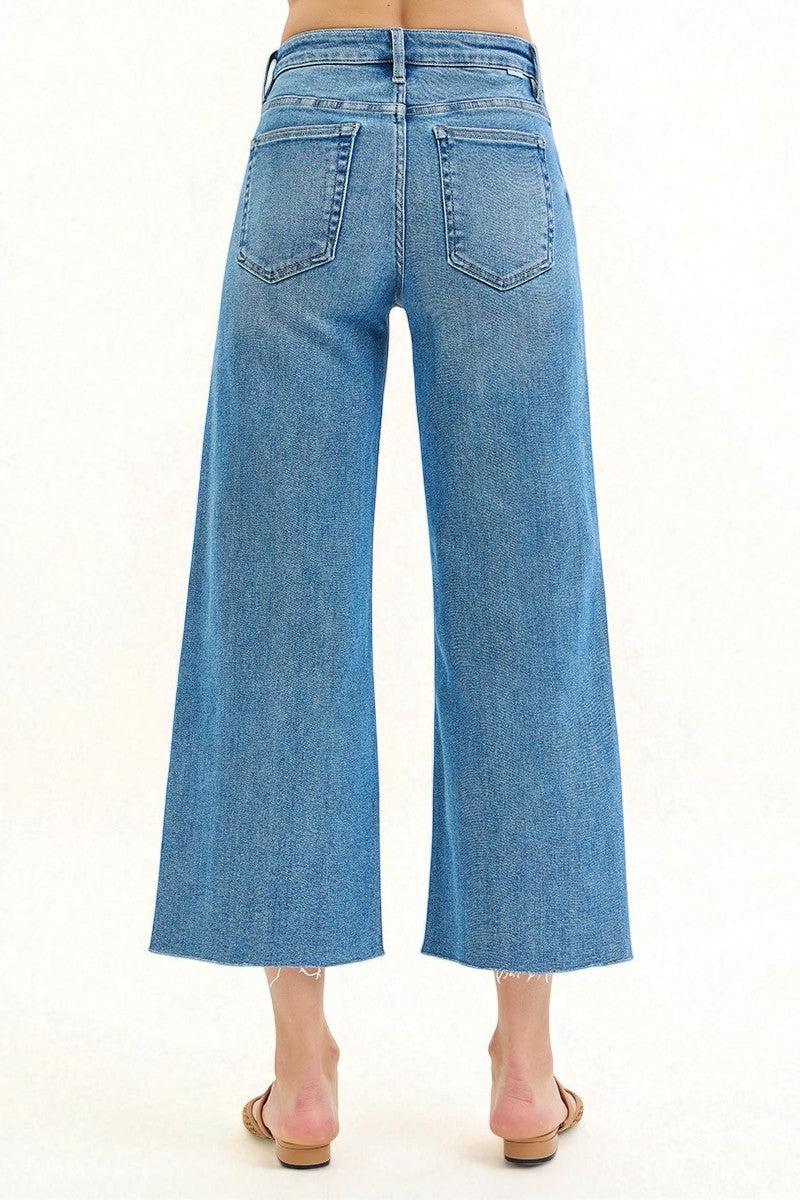 Blue jeans worn by a person on a white background