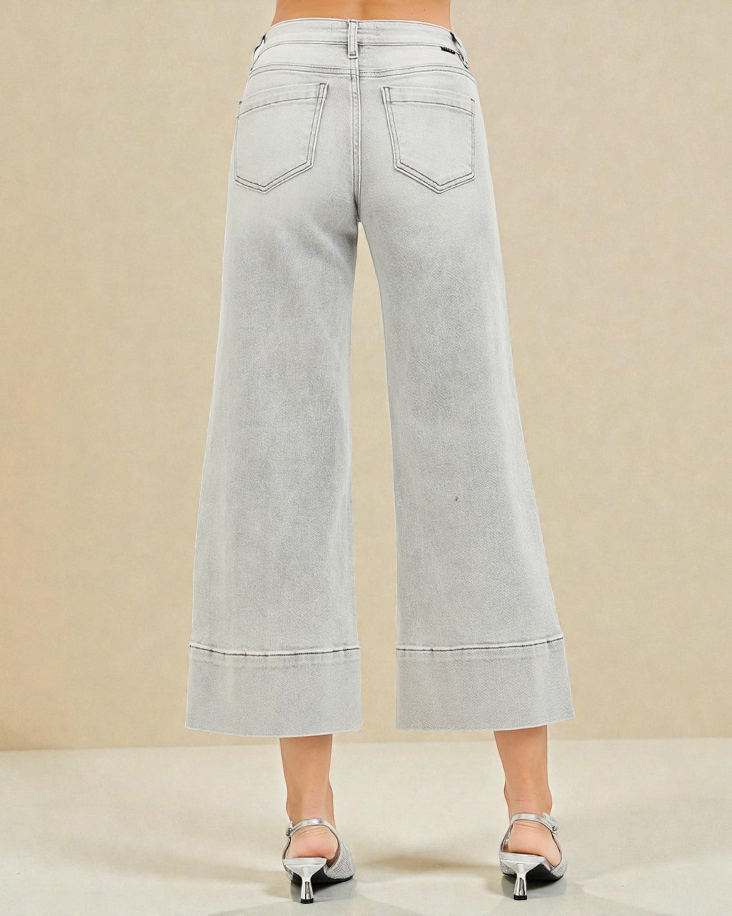 Light gray wide-leg jeans on a beige background