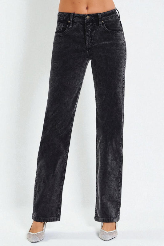 Black jeans worn by a person on a white background