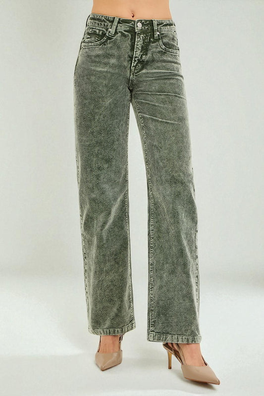 Green acid-wash jeans worn by a person on a white background