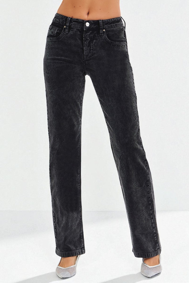 Black jeans worn by a person on a white background