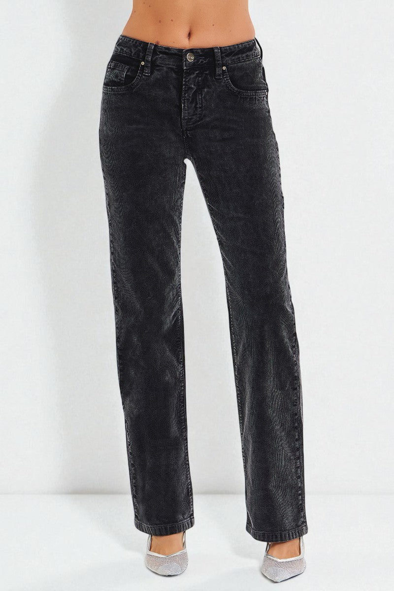 Black jeans worn by a person on a white background