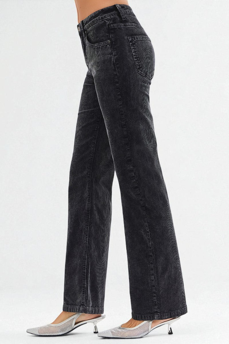 Black wide-leg jeans worn by a person on a white background