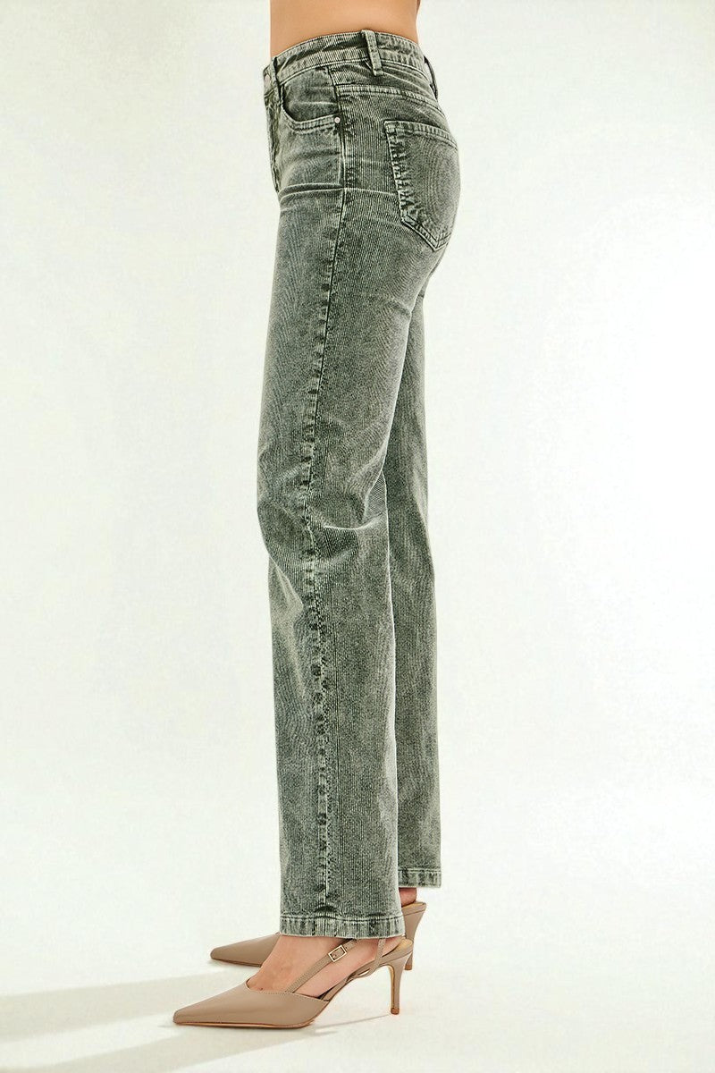 Greenish-blue jeans worn by a person on a white background