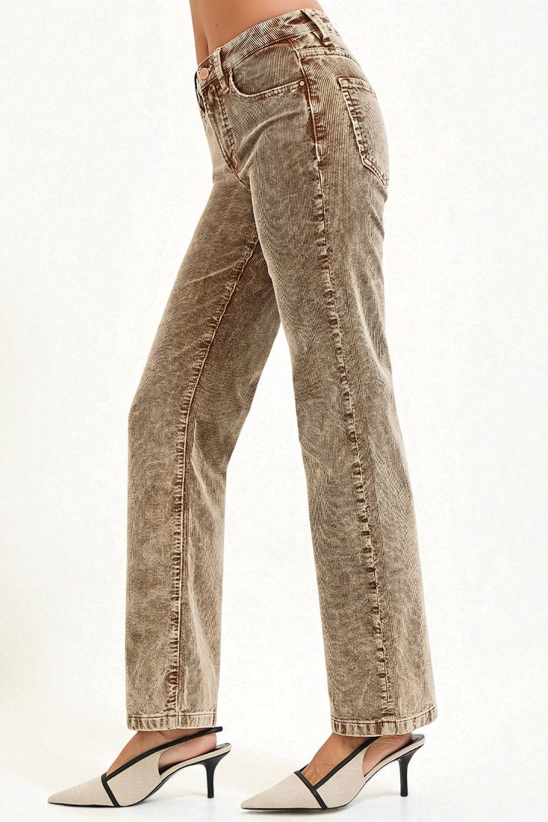 Brown acid-wash jeans worn by a person on a white background