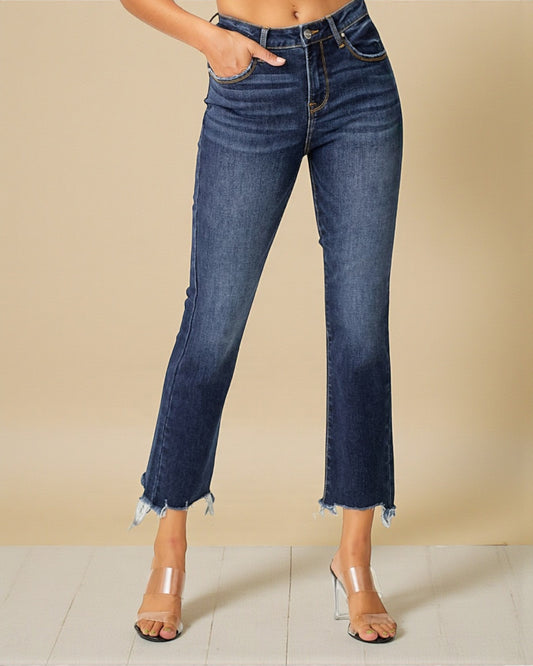 Blue jeans worn by a person on a beige background