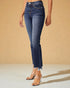 Person wearing blue jeans with a beige background