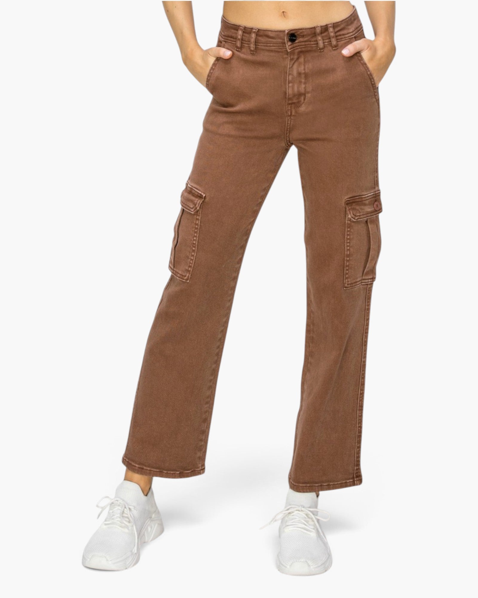 A person wearing brown wide-leg cargo pants with side flap pockets and white sneakers, shown from the waist down on a light gray studio background.