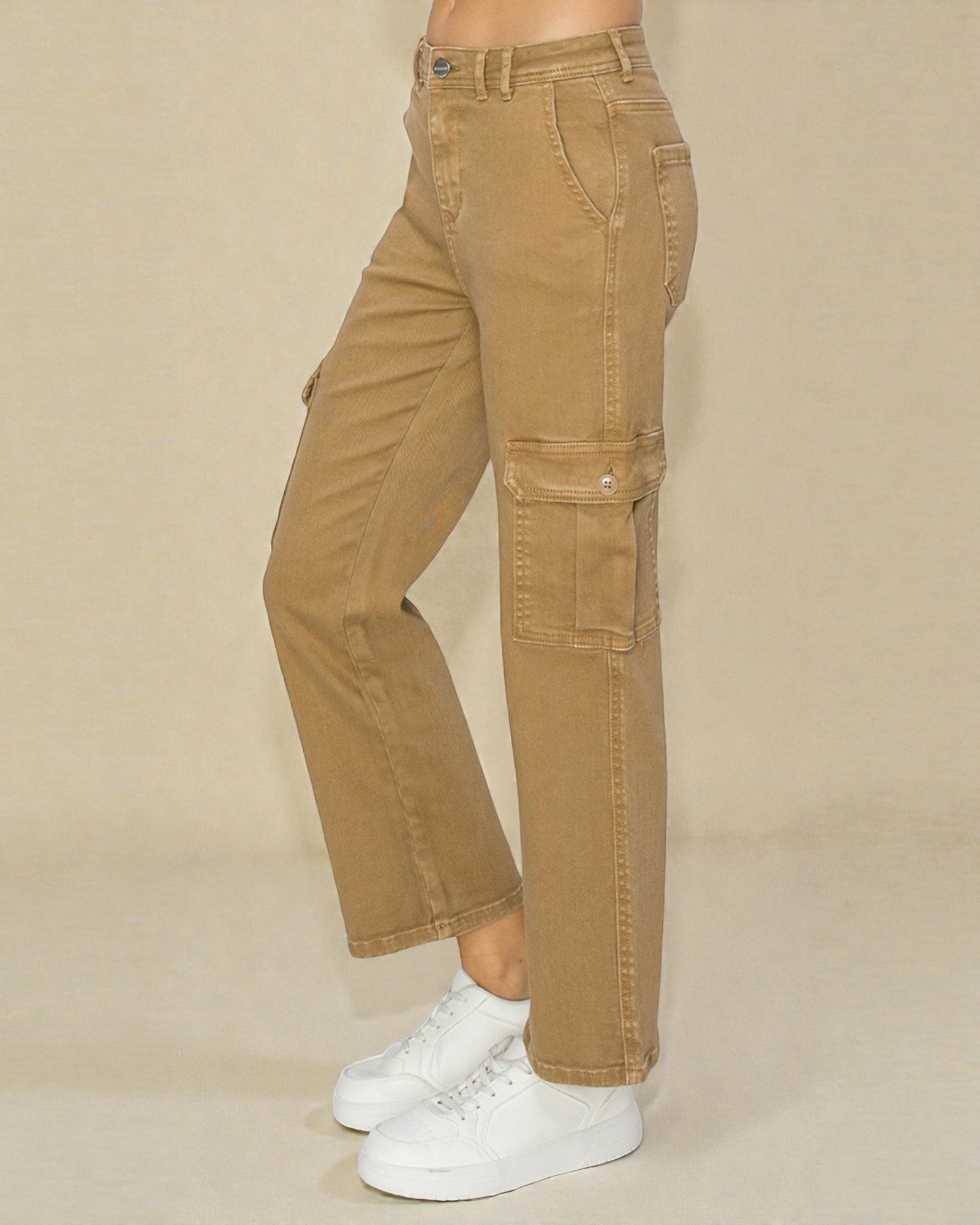 Tan cargo pants worn by a person on a beige background