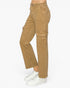 A person wearing tan cargo pants with white sneakers, shown from the waist down against a plain white studio background.