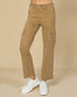 Tan cargo pants worn with white sneakers on a beige background