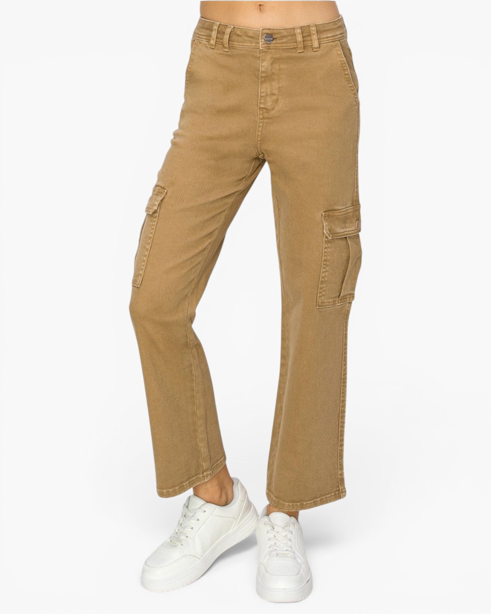 A person wearing tan cargo flare jeans with white sneakers, shown from the waist down against a plain white studio background.