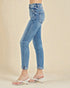 Light blue jeans worn by a person on a beige background