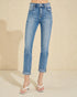 Blue jeans worn by a person on a beige background