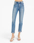 A model from the waist down wearing light blue high-waisted cropped jeans with rolled cuffs and white heeled thong sandals, set against a plain white studio background.