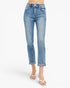A model from the waist down wearing light blue cropped denim jeans with rolled cuffs and white thong sandals, set against a plain white studio background.