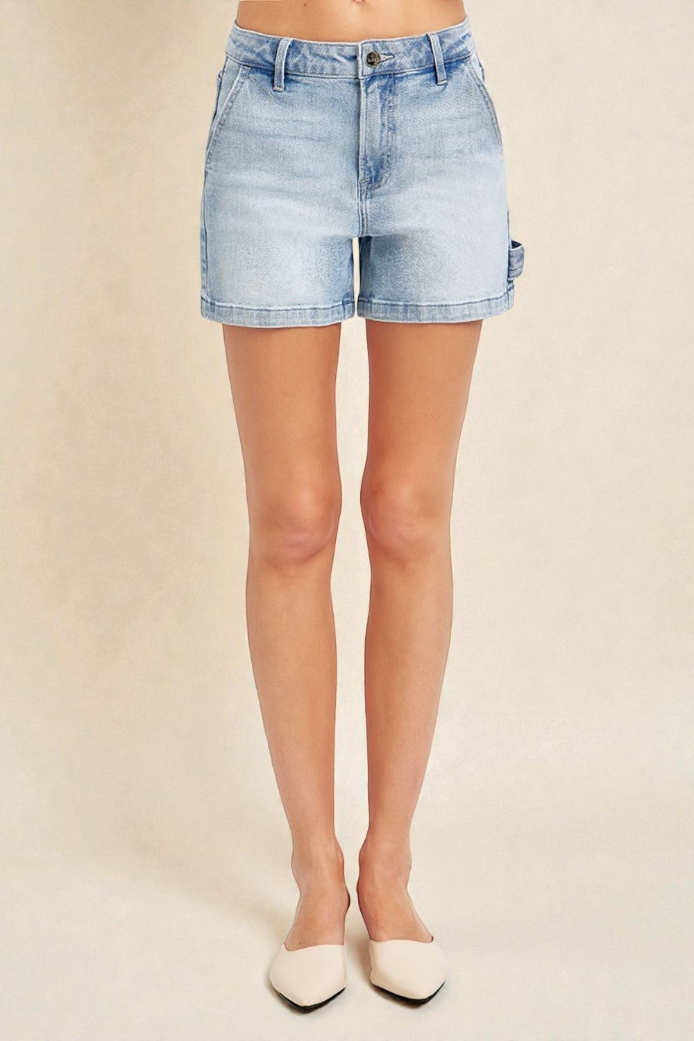 Light blue denim shorts worn by a person on a beige background