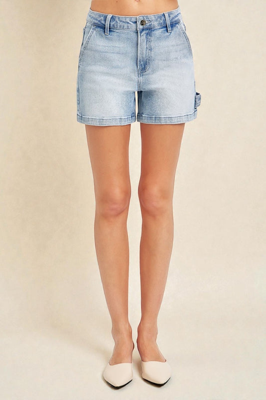 Light blue denim shorts worn by a person on a beige background