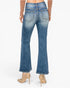 Rear view of a model wearing blue flare jeans with a faded wash, paired with beige high-heeled pumps, against a plain white background.