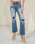 Light blue jeans with distressing details worn by a person on a neutral background